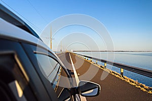 Car crossing the bridge Helio Serejo over the Parana river photo