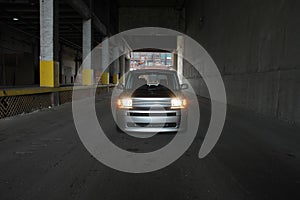 Car in a dark warehouse