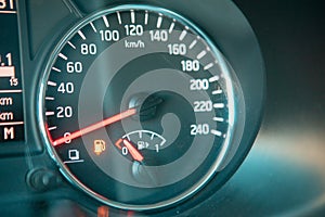 car dashboard close up low fuel warning