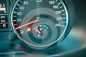 car dashboard close up low fuel warning