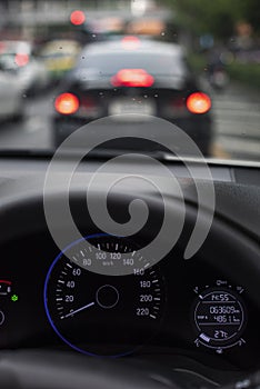 Car dashboard or console panel with Illuminated digital miles screen including gauges telling fuel, battery and lighting system.