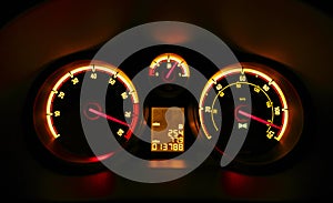 Car dashboard dials at night photo