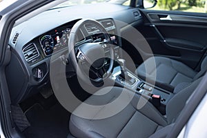 Car dashboard with a digital touchscreen. Steering wheel of a electric vehicle, interior cockpit, electric buttons