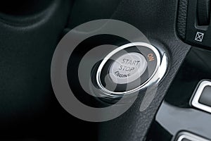 Car dashboard with focus on engine start stop button, Modern car interior details. start/stop.