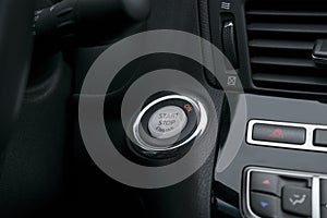 Car dashboard with focus on engine start stop button, Modern car interior details. start/stop.