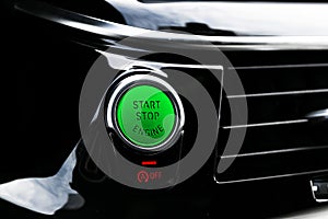 Car dashboard with focus on engine start stop button. Modern car interior details. start/stop button. Car inside. Ignition remote