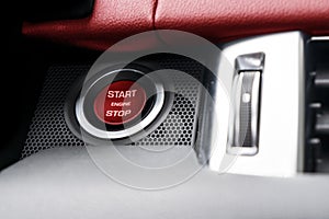 Car dashboard with focus on red engine start stop button. Modern car interior details. start/stop button. Car inside. Ignition