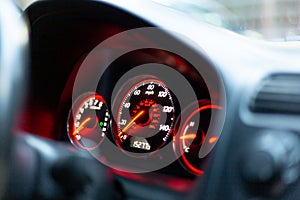 A car dashboard with spidometer