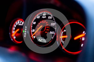 A car dashboard with spidometer