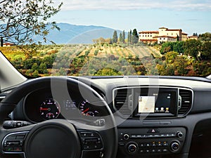 Car dashboard traveling to Tuscany