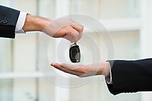 Car Dealer Giving Keys To Businessman