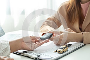 The car dealer provides advice on loans, insurance details, and car rental information, and delivers the car with the keys after
