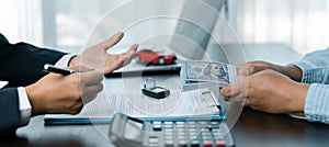 Car dealer provides advice on loans, insurance details, car rental information, delivers car with keys after the rental contract