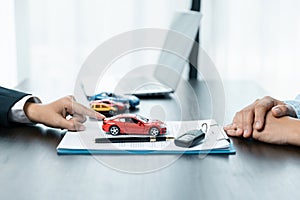 Car dealer provides advice on loans, insurance details, car rental information, delivers car with keys after the rental contract