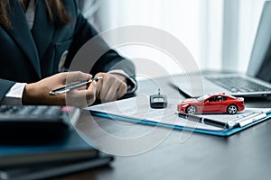 Car dealer provides advice on loans, insurance details, car rental information, delivers car with keys after the rental contract