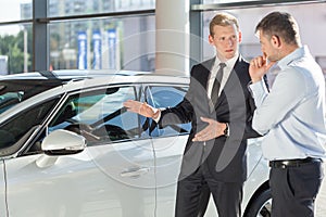 Car dealer showing vehicle