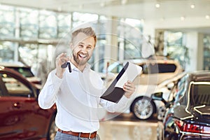 A car dealer standing in a showroom.