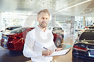 A car dealer standing in a showroom.