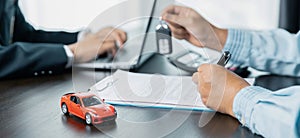 Car dealers or insurance managers cover and protect against damage and risk of driving,Hold car keys,Protecting and after-sales