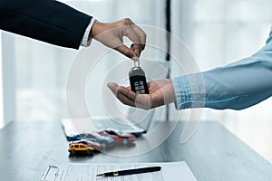 Car dealers or insurance managers cover and protect against damage and risk of driving,Hold car keys,Protecting and after-sales