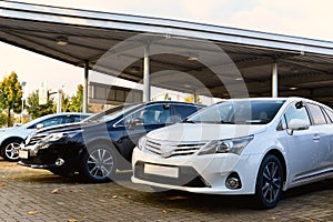 Car dealership - many vehicles parked for sale in a row