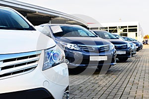 Car dealership - many vehicles parked for sale in a row