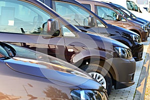 Car dealership - many vehicles parked for sale in a row