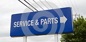 A Car dealership service and parts sign photo