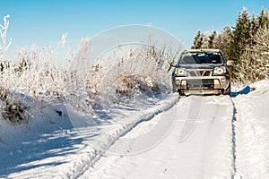 Car in deep snow road