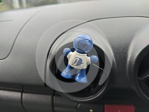 Car deodorant affixed to car air conditioner.