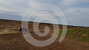 Car in desert road aerial view cutting through wild terrain Car desert symbol speed adventure. Car desert journey