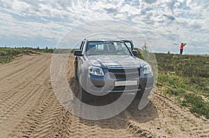 Car on desert sand road