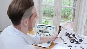 Car designer carefully analysing car prototype. Fastidious