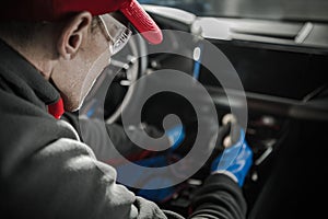 Car Detailer Cleaning Modern Vehicle Dashboard photo