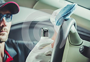 Car Detailer Cleaning and Protecting Leather Vehicle Interior