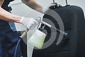 Car detailing. cloth seat upholstery cleaning with high pressure air pulse cleaning gun