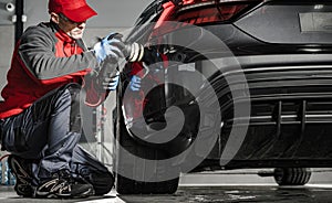 Car Detailing Worker Removing Water From a Car Body Using Soft Cloth