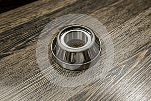 Car differential bearings on wooden background