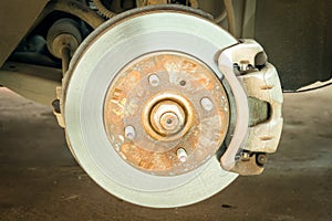 Car disc brake showing rotor and brake caliper, Car service. Close up.