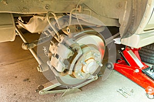 Car disc brake showing rotor and brake caliper without shock absorber, Car service.