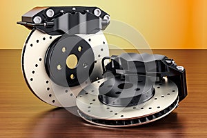 Car discs brake and calipers on the wooden table. 3D rendering