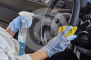 Car disinfecting service. Cleansing car interior and spraying with disinfection liquid