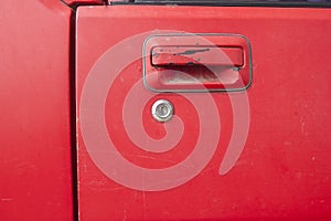 Car door - lock - old classic red car that is being repaired