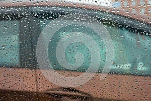 Car door through rain drops