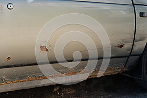 Car door with rust and metal corrosion. Need repairs, road salt damage