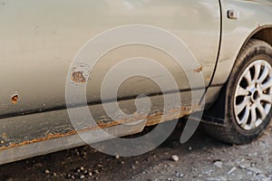 Car door with rust and metal corrosion. Need repairs, road salt damage