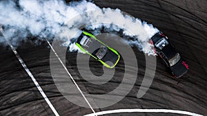 Car drift battle, Two car drifting battle on race track with smoke, Aerial view photo