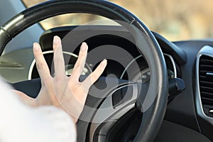 Car driver hand honking horn