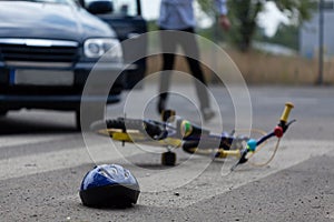 Car driver hitting little biker