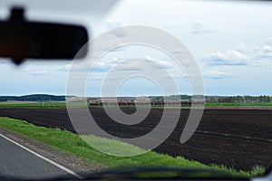 Car driver misses a train with peat on the road